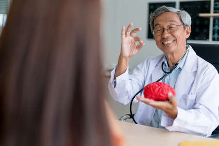asian expert doctor examine and explain to asian woman patient with care and happiness health ideas conceptの写真素材