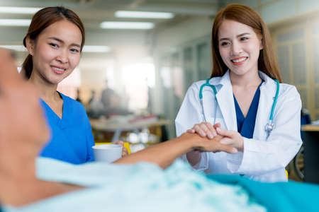 asian woman doctor encouragement and supportive to cansor patient after consult and examine in clinic hospital health ideas conceptの写真素材