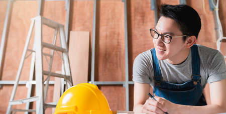 smart attractive handy glasses asian male craftman or interior designer focus wood working at site...