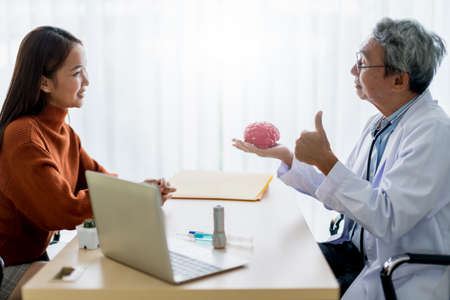 asian expert doctor examine and explain to patient with care and happiness health ideas conceptの写真素材