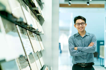asian smart male designer happiness choosing material for design projectの写真素材