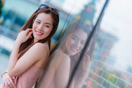 attractive asian beautiful female woman long hair casual summer cloth pink color dress smiling cheerful freshness morning moment  carefree lifestyle travel vacation momentの写真素材