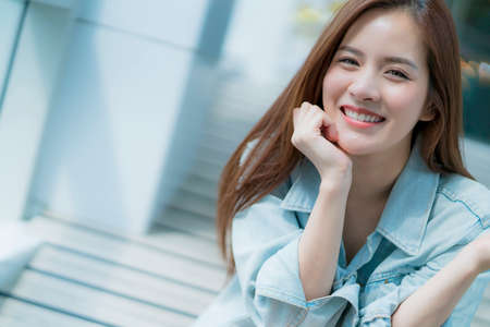 asian beautiful woman with brown long hair portrait white tshirt and jean jacket costume liftstyle conceptの写真素材