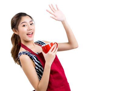 beautiful attractive asian female woman coffeeshop owner wear apron casual dress hand hold coffee dink smile with confident and cheerful welcome isolate white backgroundの写真素材