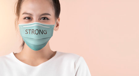 beautiful asian attractive female wear surgical mask  face protection with text strong color...