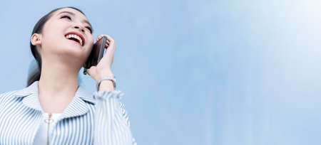 attractive smile cheerful asian female businesswoman smartphone communication technology building...