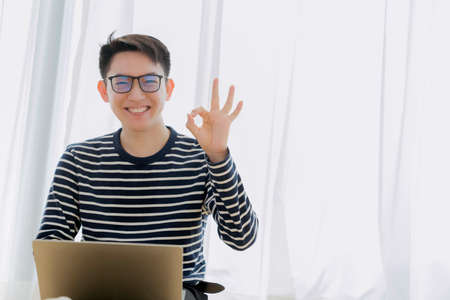 happiness asian smart casual glasses male working frome home with laptop technology with comfortable...