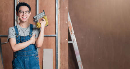 asian attractive glasses interior designer working at house site renovation construction progress...