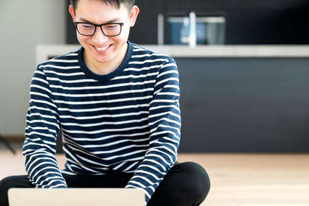 happiness peaceful smile asian male enjoy work from home quarantine  relax and positive work with...