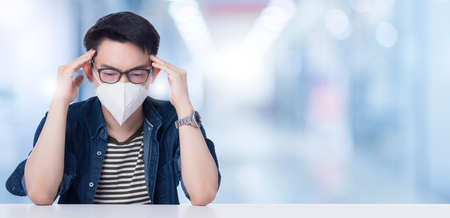 asian glasses man is wear mask covering his mouth and nose with a pollution mask to protect himself from spread pandemic of coronavirus, cold virus, flu virus, pollution.bad health conceptの写真素材