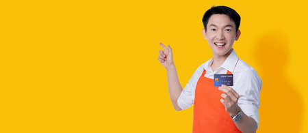asian attractive male business owner apron uniform hand gesture point finger with confident hand...