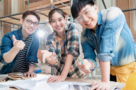 group of smart asian architect interior design team consulting with constrction engineer work...