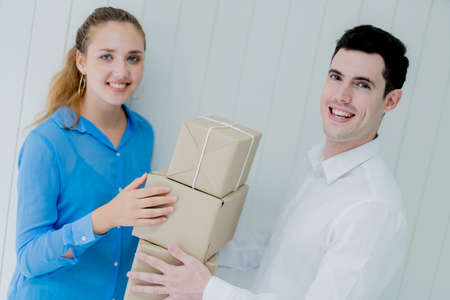 business delivery ideas concept with white shirt man sending brown box to caucasian woman with smile...