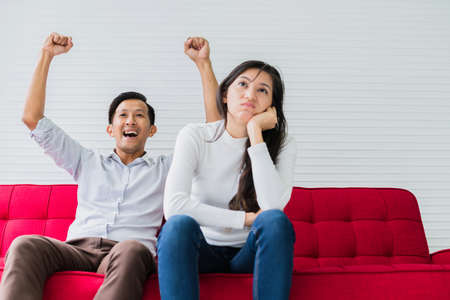 boring wife and exited husband watch sport game together