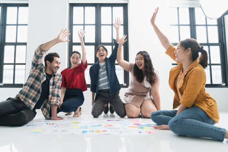 Group of asian and caucasian young creative happy enjoy laugh smile and great success emotion...
