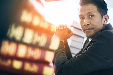 business asian man focus and thinking with money and project on table color tone image