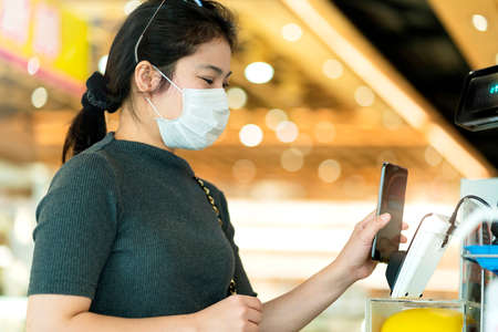 new normal after covid epidemic asian female payment progress buy scaning app by smarthine cashless...