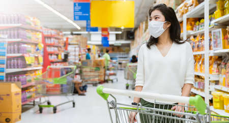 new normal after covid epidemic young smart asian female shopping new lifestyle in supermarket with...