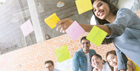 small group of creative startup business brainstorm meeting casual strategy direction together in...