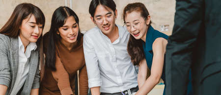 Happy colleagues discussing strategy plan during casual meeting at bright interior creative office design business ideas conceptの写真素材