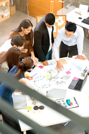 Happy businessman teamwork brainstorm and discussing on white table during business presentation in...