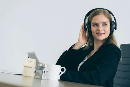 smart beauty caucasian operator contact client with tablet and headphone with happiness and joyfulの写真素材