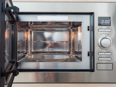 Microwave with front open in kitchenの写真素材