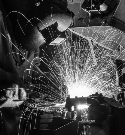 Welder movement Industrial automotive part in factory black white