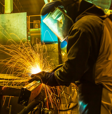 worker in automotive industry,welding working repair and grinding parts.