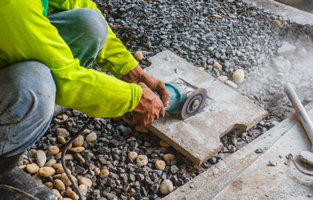 Construction workers cut bricksの写真素材