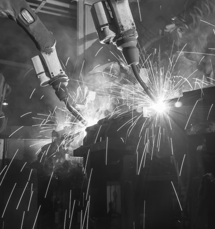 Robots Welding  movement in a car factory,black whiteの写真素材