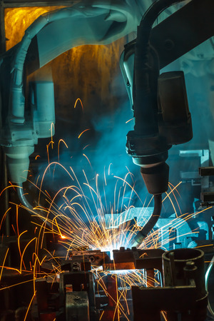 Welding robots movement in a car factoryの写真素材