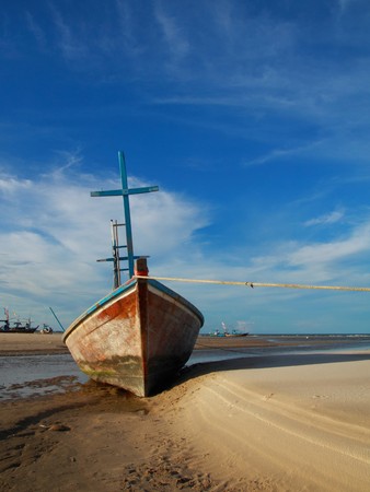 fisherman boat lying on the tropical beachの写真素材