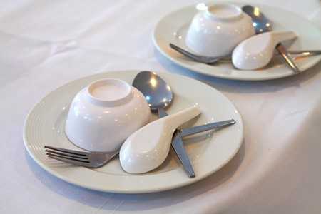Thai resturant Place setting, A dish, bowl, spoon and fork on a tableの写真素材