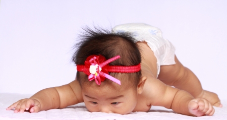 asia baby try to crawl. she is my daugther.の写真素材
