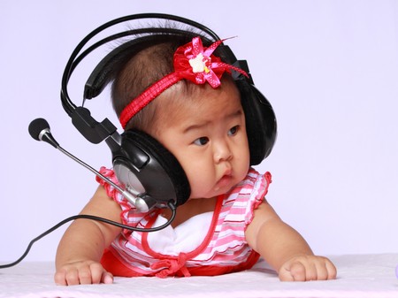 asia baby with black headphones.she is six month.の写真素材