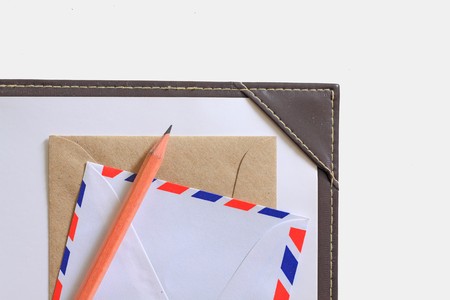 Letter paper, envelope and a wooden pencil isolated in white.