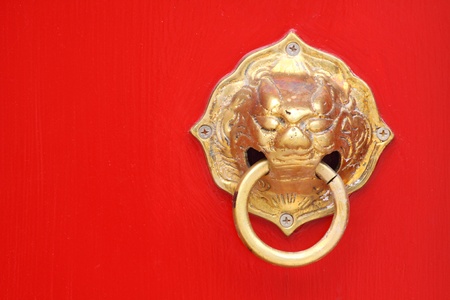 Tradtional asian door knob with a lion guardian carving as a handle.の写真素材