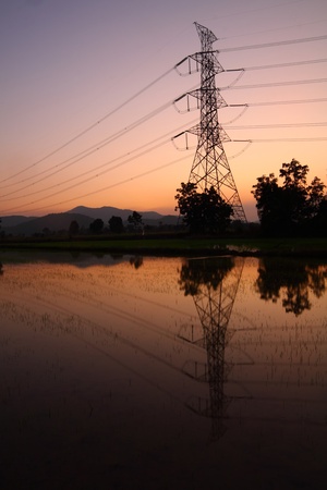 High voltage electrical pylons and wires on sunset backgroundの写真素材
