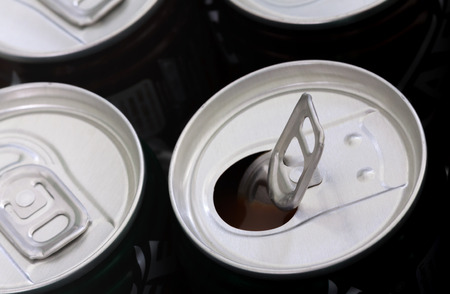 closeup shot of a bunch of aluminum cans with opened one