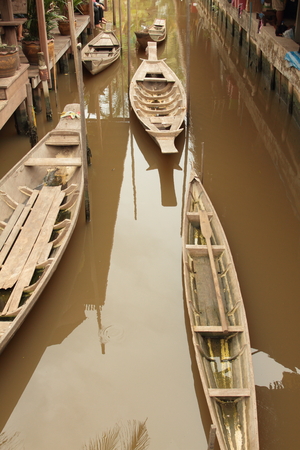 thai traditional wooden boat on canal represented traditional life styleの写真素材