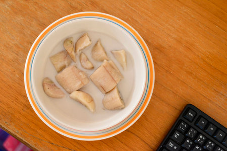 Banana in coconut milk, on the desk.の写真素材