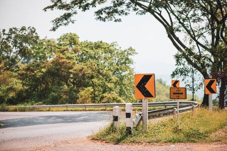 Mountain road with traffic signsの写真素材