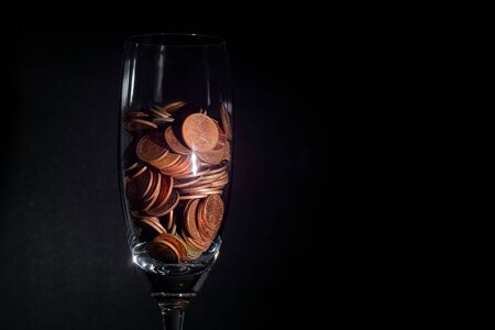 Thai currency coins in glass, black background