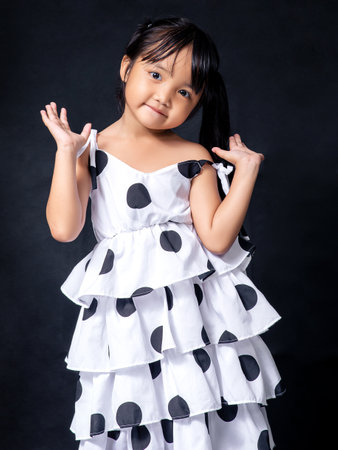 Children dressed in white prepare to go on a weekend trip.の写真素材