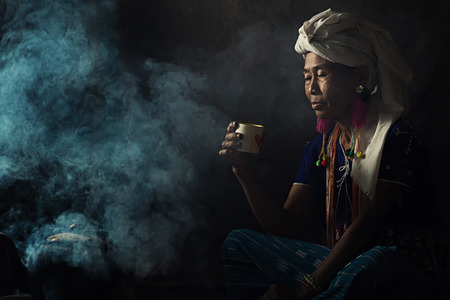 Tribal women are smelling scents aromatic coffee. She planted herself.の写真素材