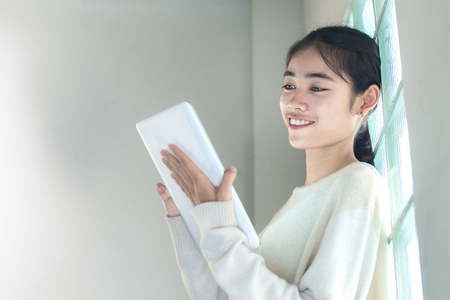 asian woman using tablet computer.student enjoy with content from e-book.の写真素材