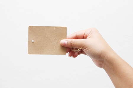 Hand and a card on whiteの写真素材