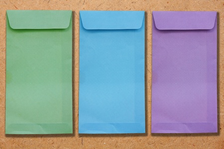 Three envelopes on the plywood. 