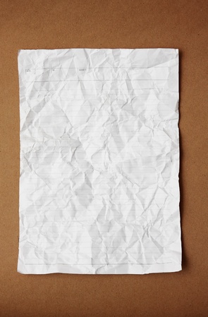 White crumpled paper on brown backgroundの写真素材